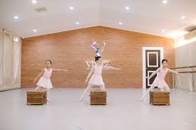 Young ballet students practicing positions in a Chiang Mai dance studio